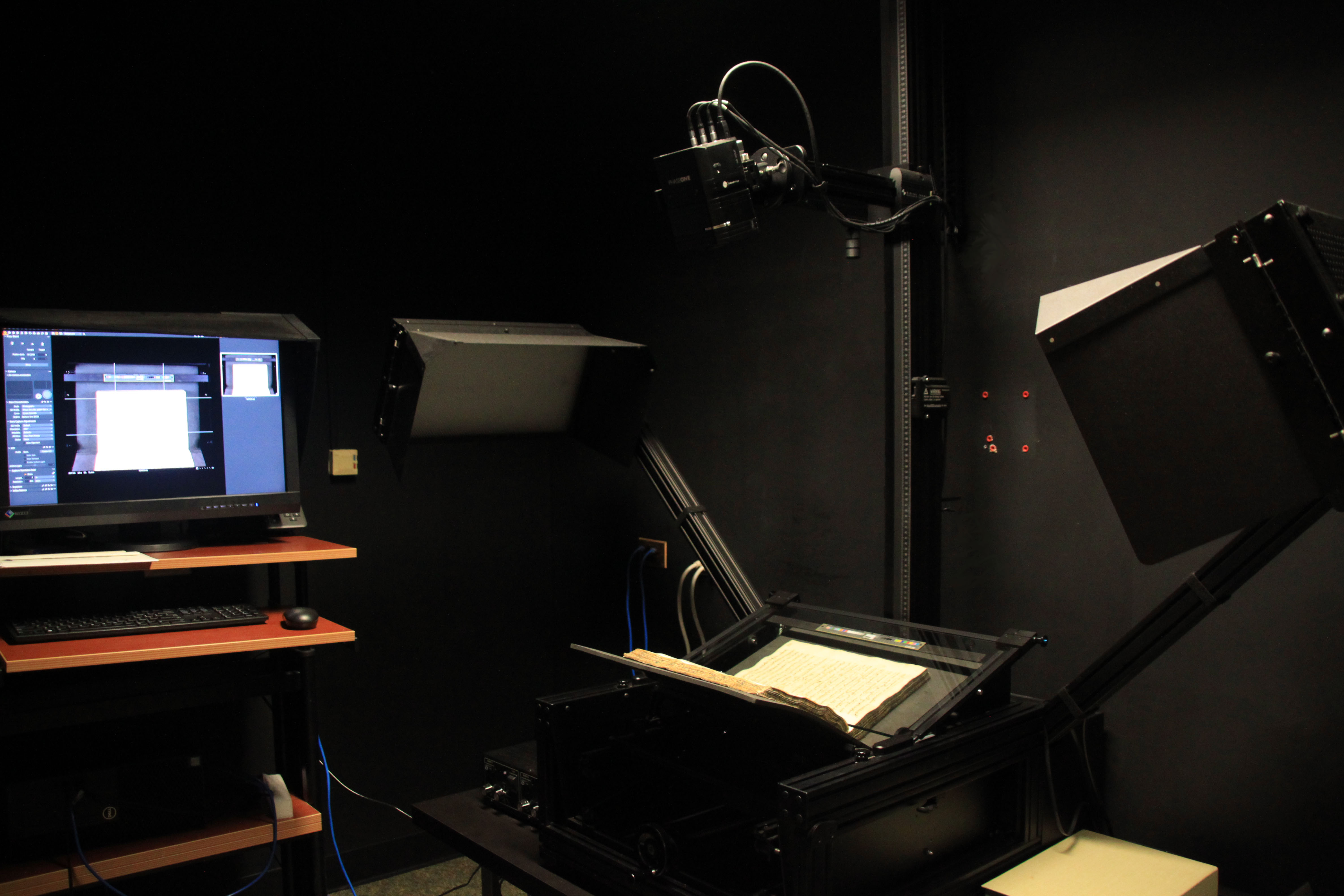 A dark photo studio with a book on a copystand