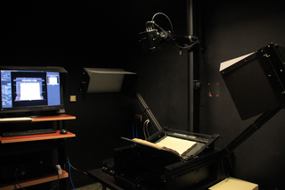 A dark photo studio with a book on a copystand